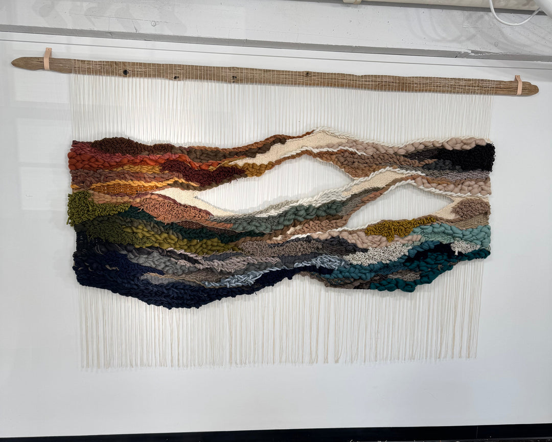 textile art piece in earthy tones.